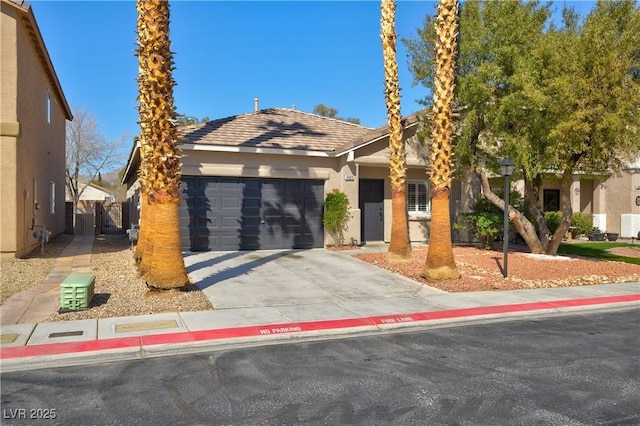 view of front of house with a garage, driveway, and stucco siding