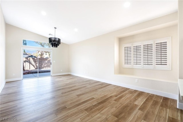 unfurnished dining area featuring baseboards, an inviting chandelier, vaulted ceiling, light wood-type flooring, and recessed lighting