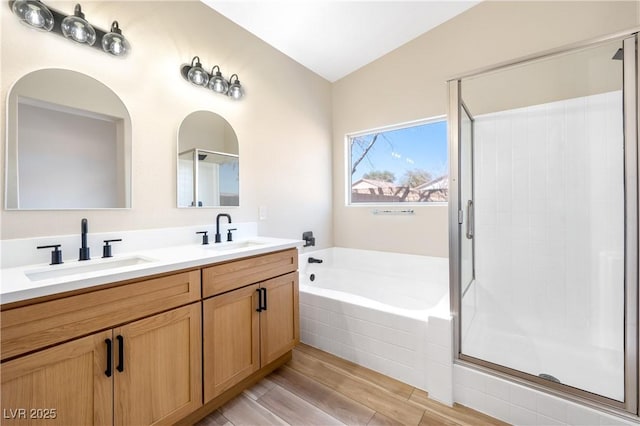 bathroom featuring a garden tub, a sink, and a stall shower