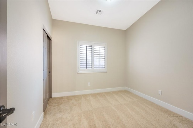 unfurnished bedroom with a closet, visible vents, light carpet, and baseboards