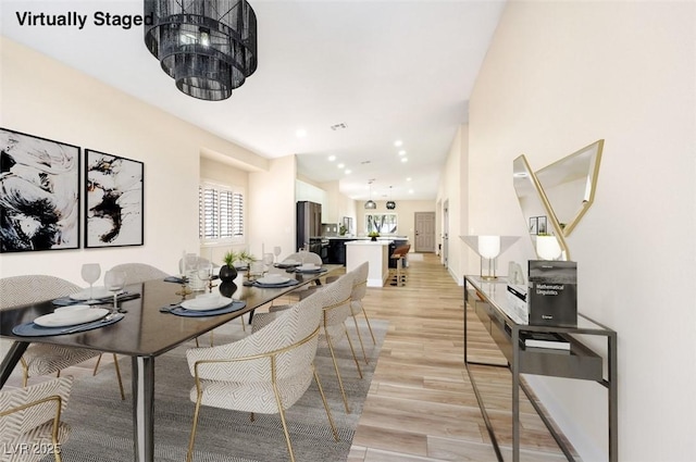 dining room with light wood-style floors, recessed lighting, and visible vents