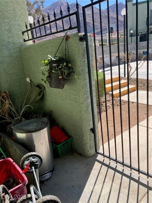 exterior space featuring a mountain view and a gate