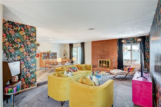 carpeted living area with visible vents, a fireplace, and a textured ceiling