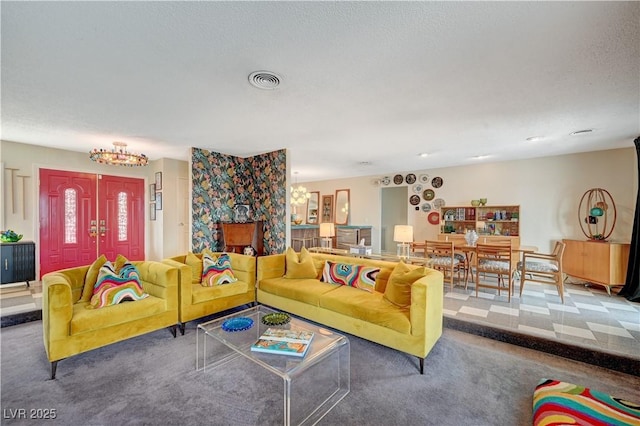 carpeted living area featuring visible vents and a textured ceiling