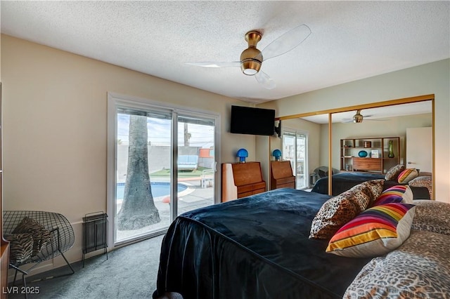 carpeted bedroom featuring access to outside, a closet, ceiling fan, and a textured ceiling