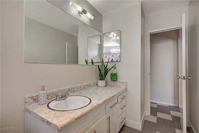 bathroom featuring baseboards, vanity, and tile patterned floors