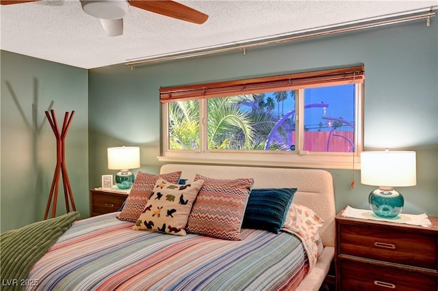 bedroom with a ceiling fan and a textured ceiling