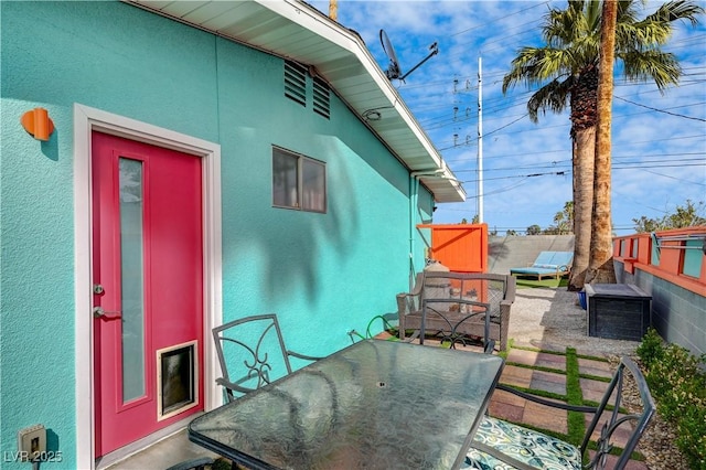 view of patio featuring fence and outdoor dining area