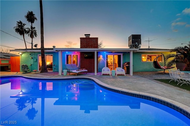 pool with a patio area and central air condition unit