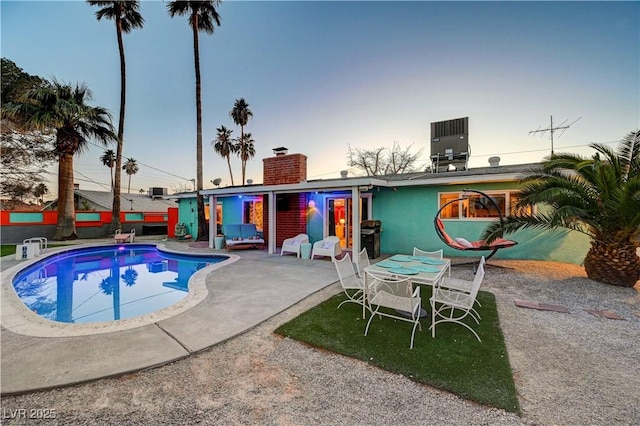 view of pool with central AC and a patio area