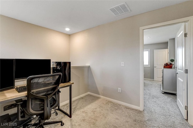 carpeted office with visible vents and baseboards