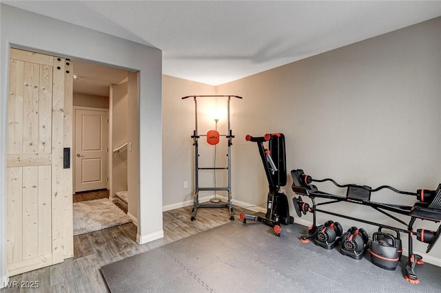 exercise room featuring wood finished floors and baseboards