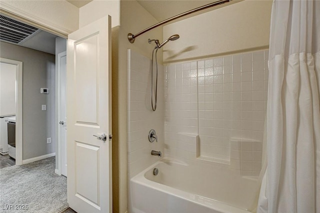 full bath featuring baseboards, washer / clothes dryer, visible vents, and shower / bathtub combination with curtain