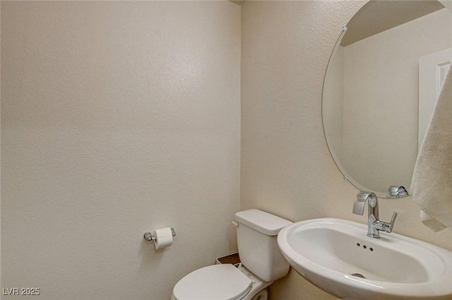 half bathroom with a sink and toilet