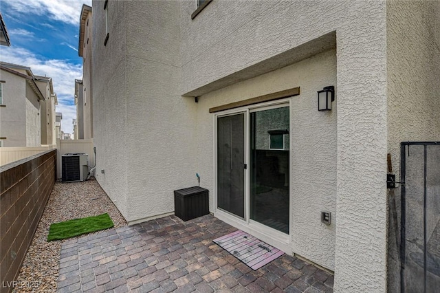 view of patio / terrace featuring central AC and fence