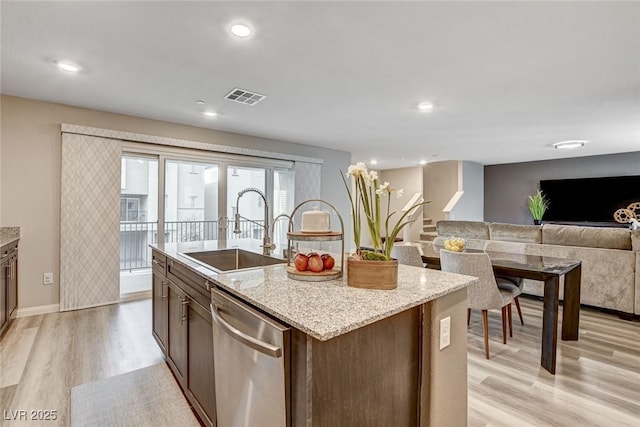 kitchen with light wood-style flooring, a sink, visible vents, open floor plan, and dishwasher