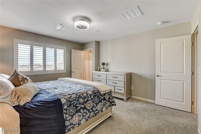 bedroom featuring baseboards, visible vents, and light colored carpet