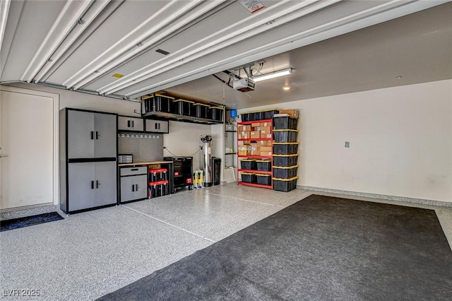 garage featuring baseboards and a garage door opener