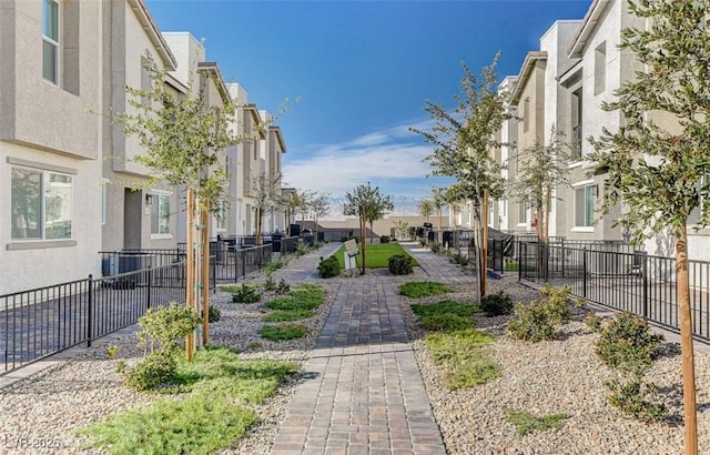 surrounding community with fence and a residential view