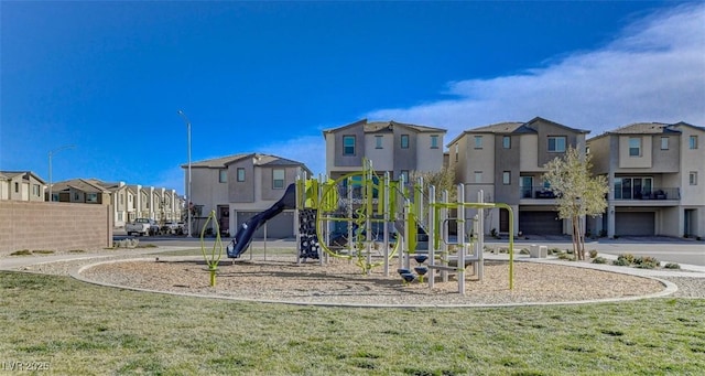 community playground featuring a residential view and a yard