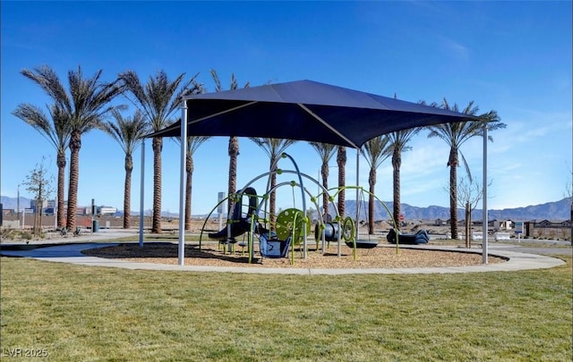 community jungle gym featuring a lawn and a mountain view