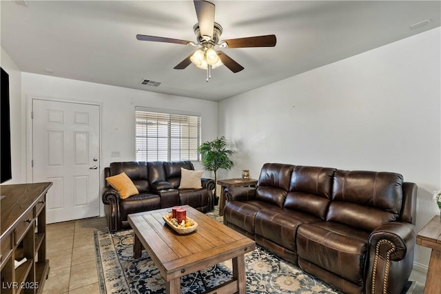 living room with light tile patterned floors, visible vents, and a ceiling fan