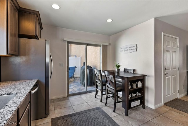 dining area featuring recessed lighting, light tile patterned flooring, and baseboards