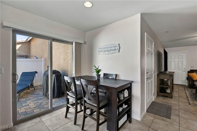 dining area with light tile patterned floors, baseboards, and recessed lighting