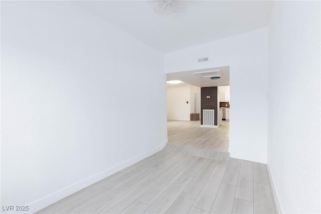 interior space with visible vents, light wood-style flooring, and baseboards