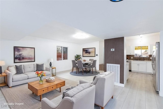 living room with visible vents and light wood-style flooring