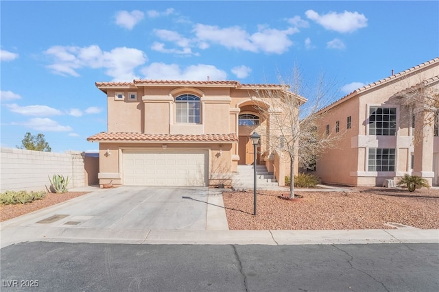 mediterranean / spanish-style home featuring stucco siding, fence, a garage, driveway, and a tiled roof