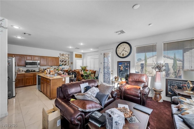 living area featuring visible vents and recessed lighting