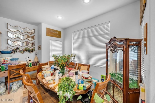 tiled dining space featuring recessed lighting