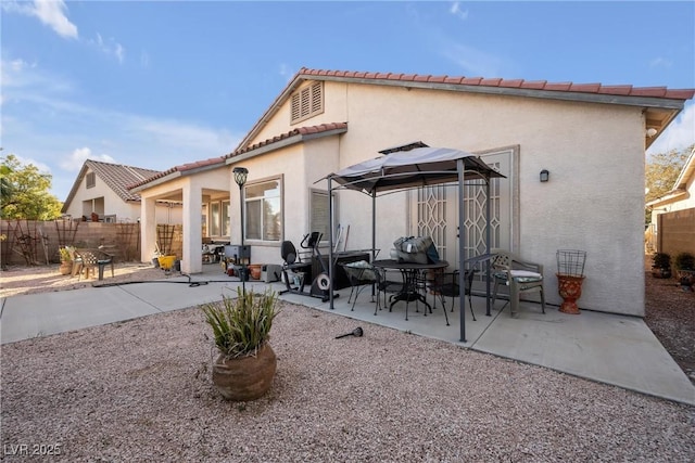 back of property with a patio area, fence, and stucco siding