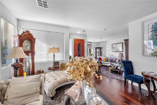 living area with wood finished floors and visible vents