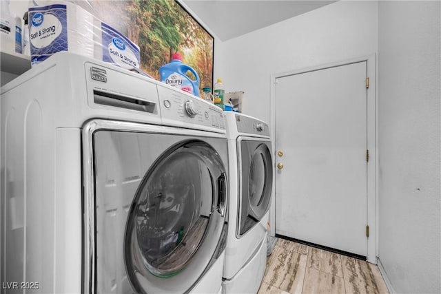 laundry room with light wood-style floors, laundry area, and separate washer and dryer