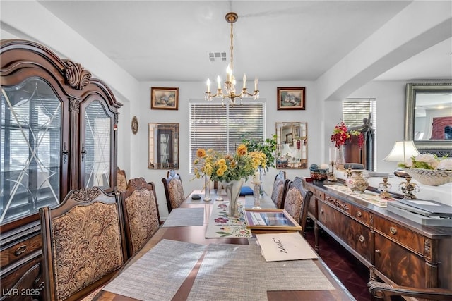 dining area with an inviting chandelier and visible vents