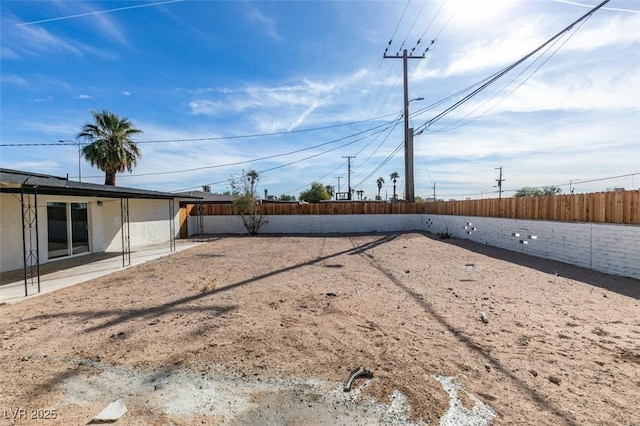 view of yard featuring a patio area and a fenced backyard