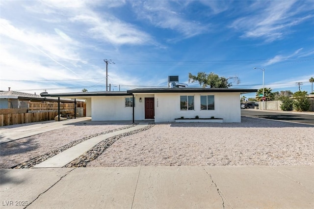 single story home with fence