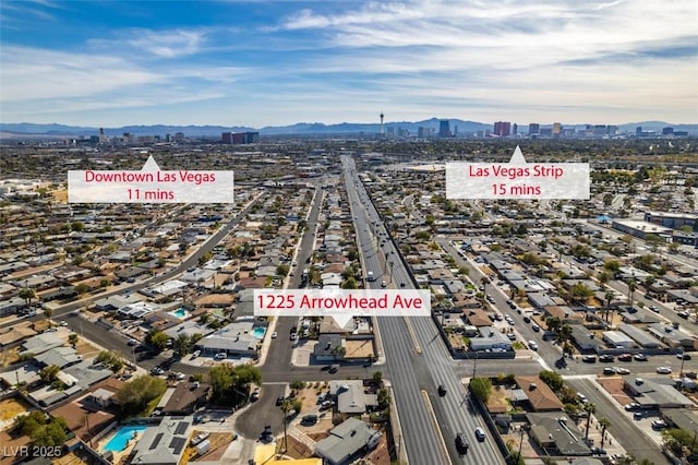 drone / aerial view featuring a mountain view and a city view