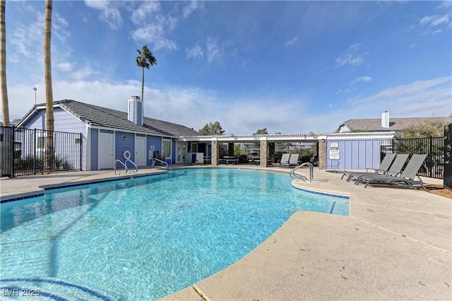 community pool with a patio and fence