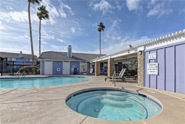 community pool with a community hot tub, a patio, and fence