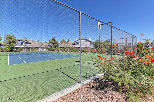 view of sport court featuring fence