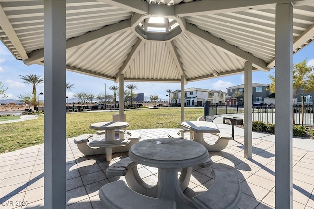 view of patio / terrace with a residential view, fence, and a gazebo