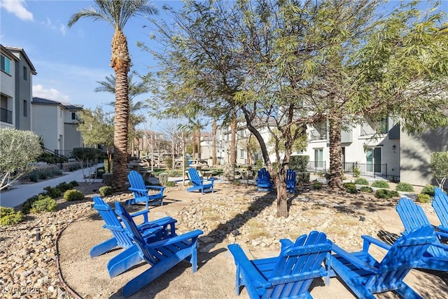 view of property's community with a residential view, a patio, and fence