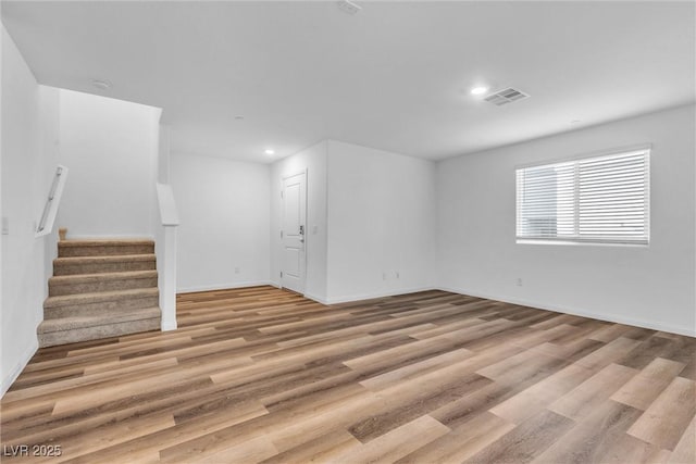 interior space with recessed lighting, wood finished floors, visible vents, baseboards, and stairs