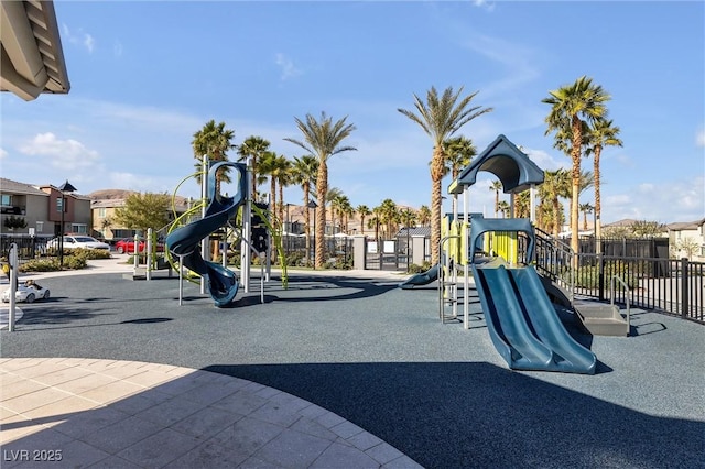 community jungle gym with a residential view and fence