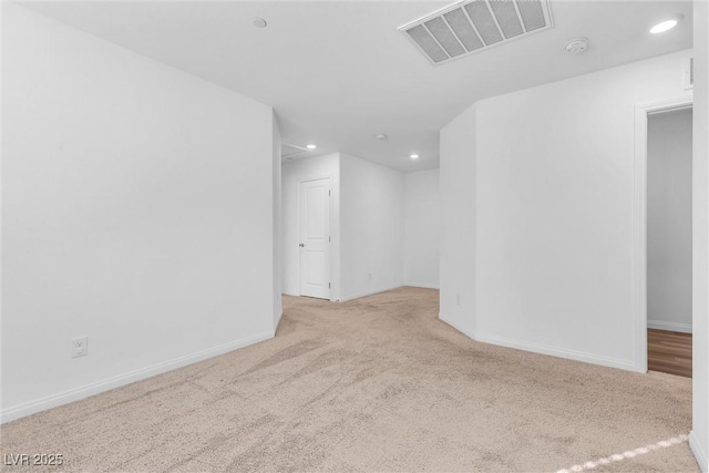 carpeted empty room with recessed lighting, visible vents, and baseboards