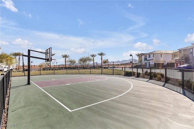 view of basketball court featuring community basketball court and fence