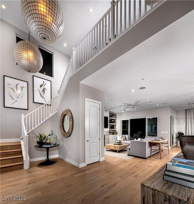 living room with baseboards, a ceiling fan, stairway, wood finished floors, and recessed lighting